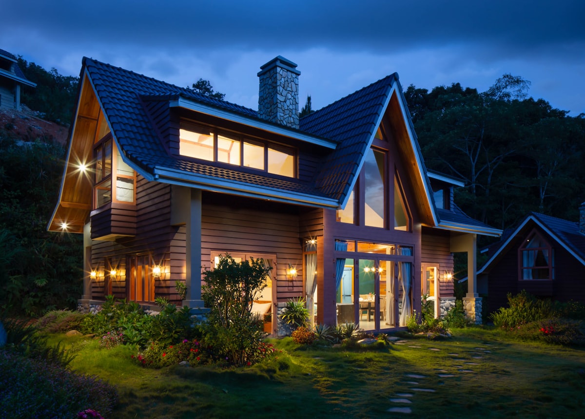 A warmly-lit residential home at dusk